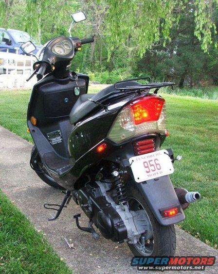 Black scooter rear view with license plate reading 956 MOPED