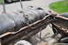 1986 Ford Bronco - The fuel tank and frame components are visible, showing significant rust and wear.
