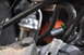 1986 Ford Bronco - Engine bay detail showing hoses, a drive belt, and various metal parts.