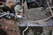 1986 Ford Bronco - Close-up view of aged vehicle undercarriage components, including a brake line and wiring.