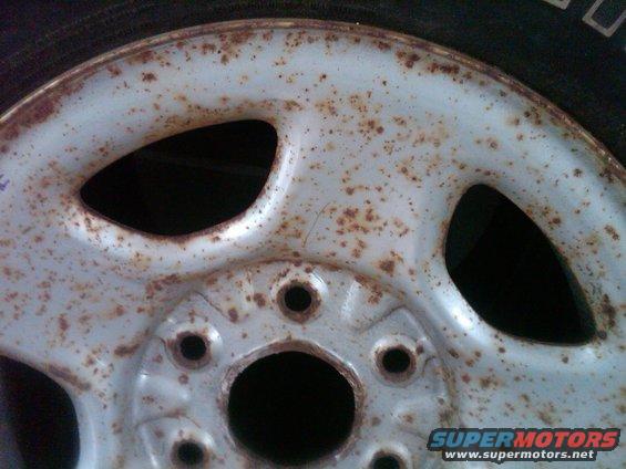 Rusted wheel with five lug nut holes