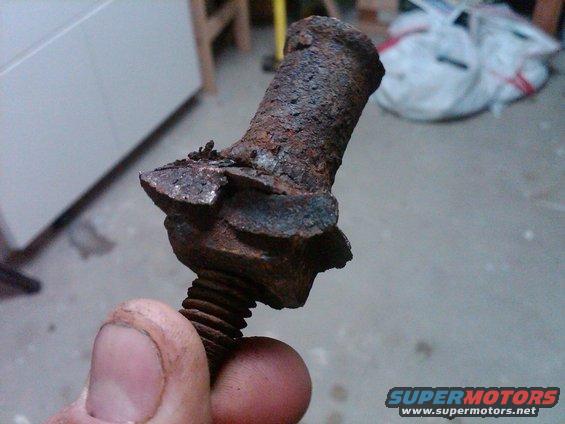 Heavily rusted bolt held in fingers