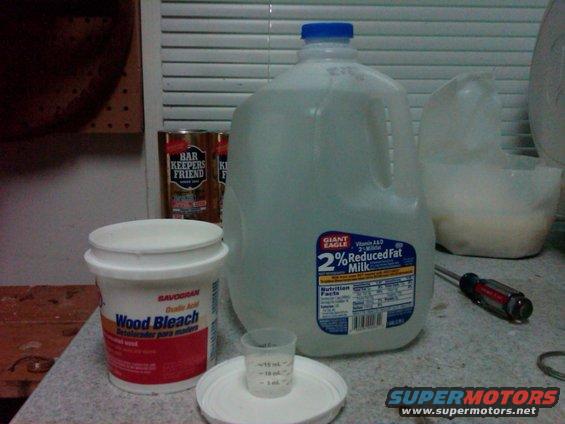 Wood bleach, Bar Keepers Friend, and a gallon of 2% milk on a counter