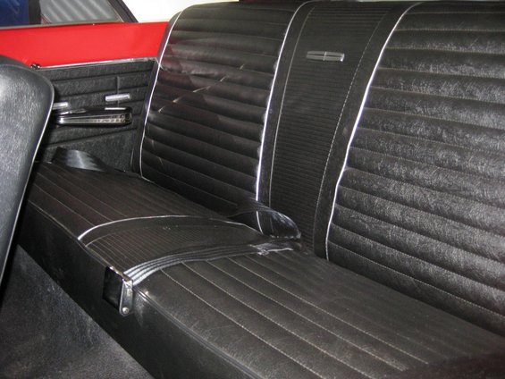 Black vinyl bench seat with white piping and chrome trim. 1964 Ford Fairlane interior