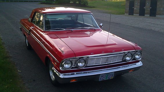 Red 1964 Ford Fairlane parked outside
