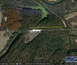 1995 Mercury Grand Marquis - An aerial perspective captures a landscape a body of water, a road, and several long, narrow structures.