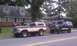 1979 Ford Bronco - Two Ford Broncos, one from the late 70s and a lifted later model, sit parked on a suburban street.