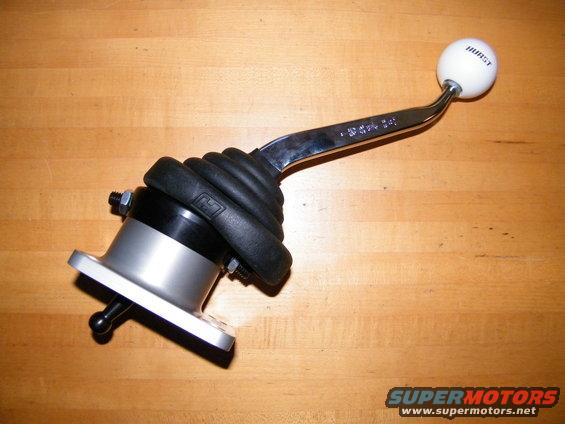 Hurst shifter with white shift knob and black rubber boot