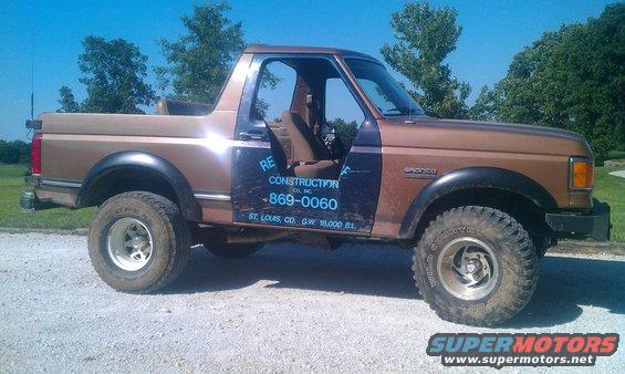 1987 Ford Bronco with "RE Construction Co." text on the door