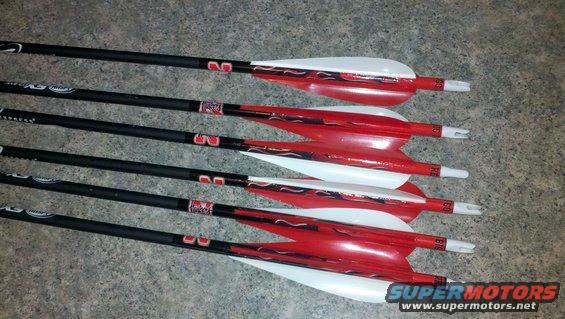 Five red and white arrows with black shafts