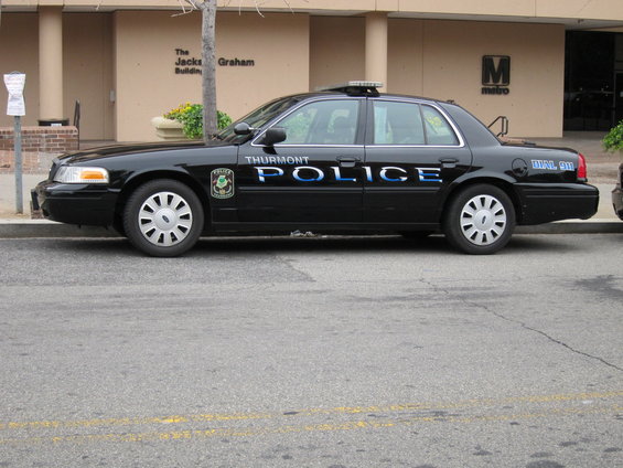 Black police car with "THURMONT POLICE" text on the side, parked curbside
