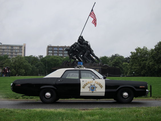 Highway Patrol car side view, black and white with blue light bar