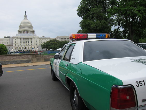 Police car with light bar parked near the US Capitol building