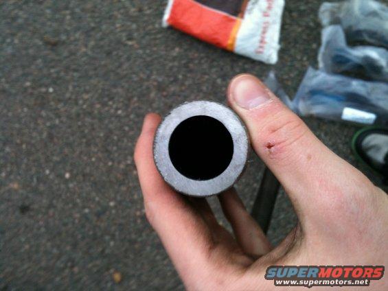 Metal tube held in hand, showing hollow center