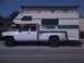 1997 Dodge 3500 - This 1997 Dodge 3500 pickup truck is equipped with a large camper shell, extending its utility for travel and accommodation.