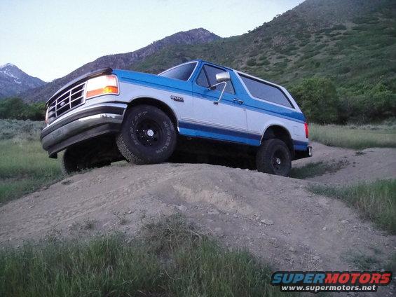 Blue and white 1994 Ford Bronco on a dirt hill