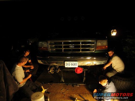 1992 Ford Bronco front end with people working on suspension