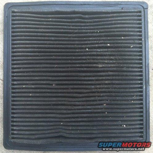 Dirty air filter with black pleats and a black frame. Supermotors.net logo in the corner