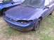 1999 Ford Escort - A blue sedan with a damaged front end sits on grass next to another blue vehicle.