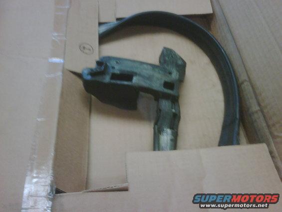 car door handle mechanism and trim piece in a cardboard box