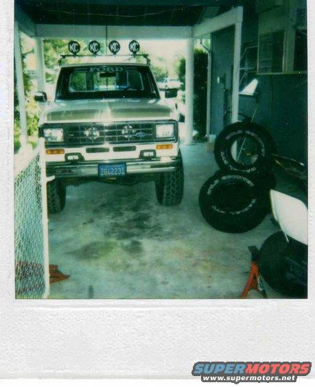 1999 Ford Ranger pickup truck with KC lights on roof rack, parked in garage