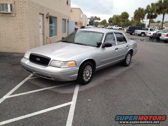 Silver 2005 Ford Crown Victoria parked in a lot, front 3/4 view