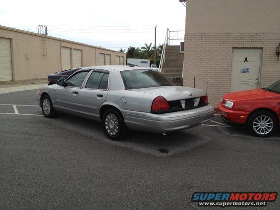 Silver 2005 Ford Crown Victoria parked next to a red car