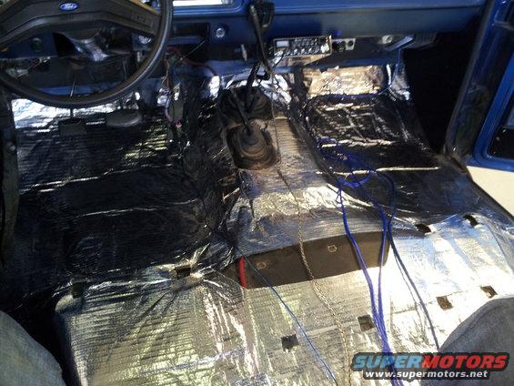 Interior of vehicle with soundproofing material and wiring on the floor