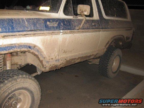 Muddy SUV, side view. Looks like a 70s Ford Bronco