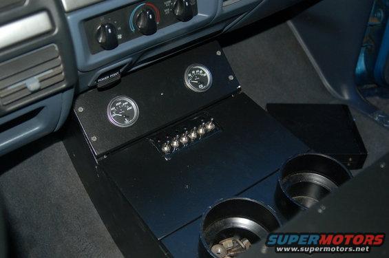 1992 Ford F-150 interior showing a custom black console with gauges and switches, and two cup holders
