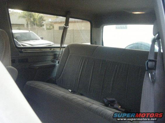 Interior view of a 1993 Ford Bronco, showing the rear bench seat and a glimpse of the exterior through the windows