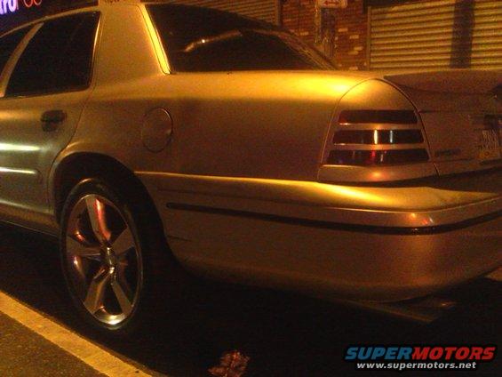 Rear quarter view of a gold Ford Crown Victoria from the 2003-2011 generation