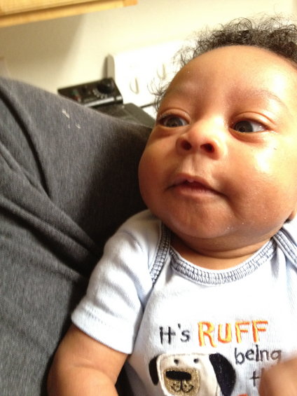 Baby wearing a light blue onesie with the text 'It's RUFF being a dog'