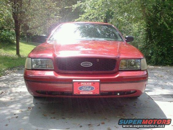 Front view of a red 2000 Ford Crown Victoria Police Interceptor parked on a driveway