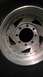 1989 Ford Bronco - A close-up view of a silver alloy wheel and tire.