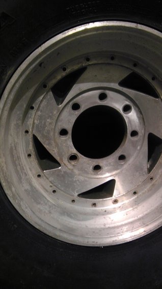 Close-up of a silver alloy wheel with a black tire