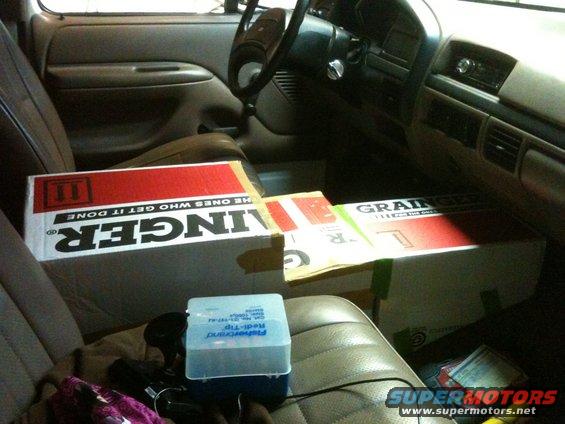 Interior view of vehicle with boxes on seats