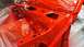 1983 Ford Bronco - A car frame is covered in red paint and plastic sheeting, awaiting further work.