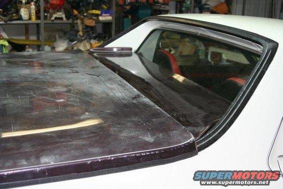 1976 Ford Ranchero bed cover and rear window frame. Interior shows red and black seats