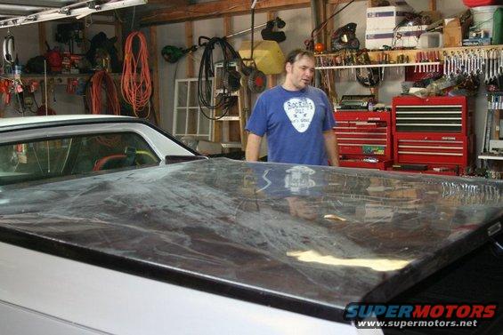 Bed cover on a white vehicle in a garage