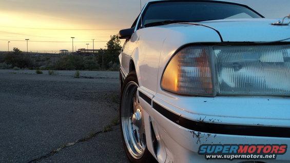 White 1989 Ford Mustang front corner with sunset sky