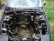 1989 Ford Probe - The engine bay of a vehicle is shown with the engine removed, revealing the internal components and wiring harness.