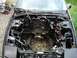 1989 Ford Probe - The engine bay of a 1989 Ford Probe is shown with the engine removed, revealing its internal components and wiring.