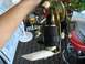 1989 Ford Probe - A person holds a fuel pump assembly, which includes a black filter and various electrical connectors.