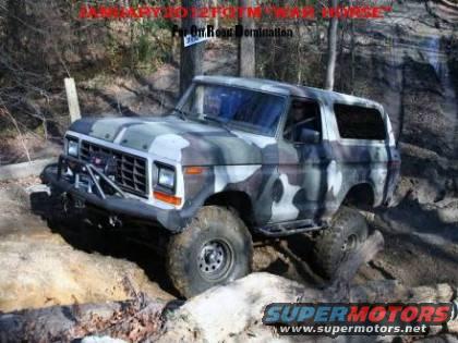 Camouflaged SUV on a rocky trail, front bumper has a brush guard