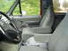 1993 Ford Bronco - Interior view of a 1993 Ford Bronco, showing the front seats, steering wheel, and door panel.