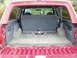 1993 Ford Bronco - Rear view of the cargo space in a 1993 Ford Bronco, showing the folded seat and floor.