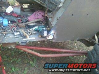 Vehicle body panel with tools and red metal bars in front