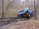 1989 Ford Bronco - Ford Bronco tackling a challenging muddy off-road course.