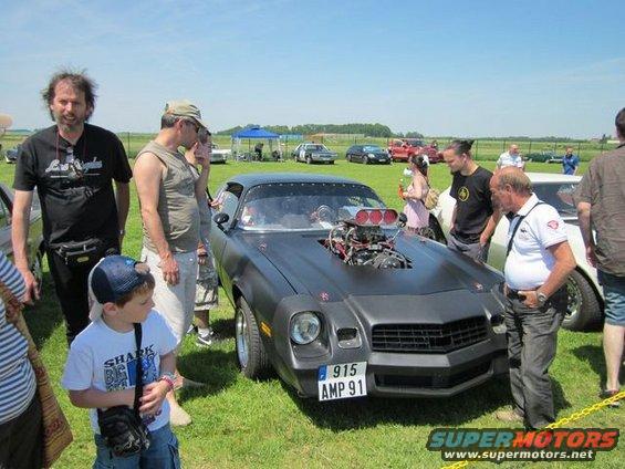 Modified 1981 Chevrolet Camaro with exposed engine and custom grille. License plate reads 915 AMP 91